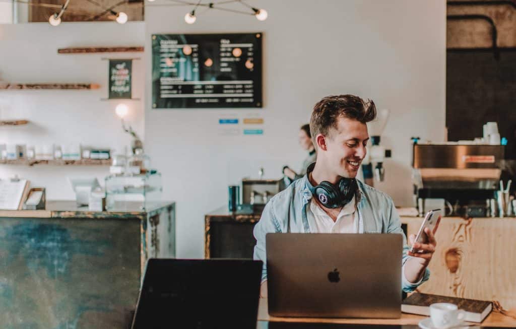 Producer on laptop in cafe