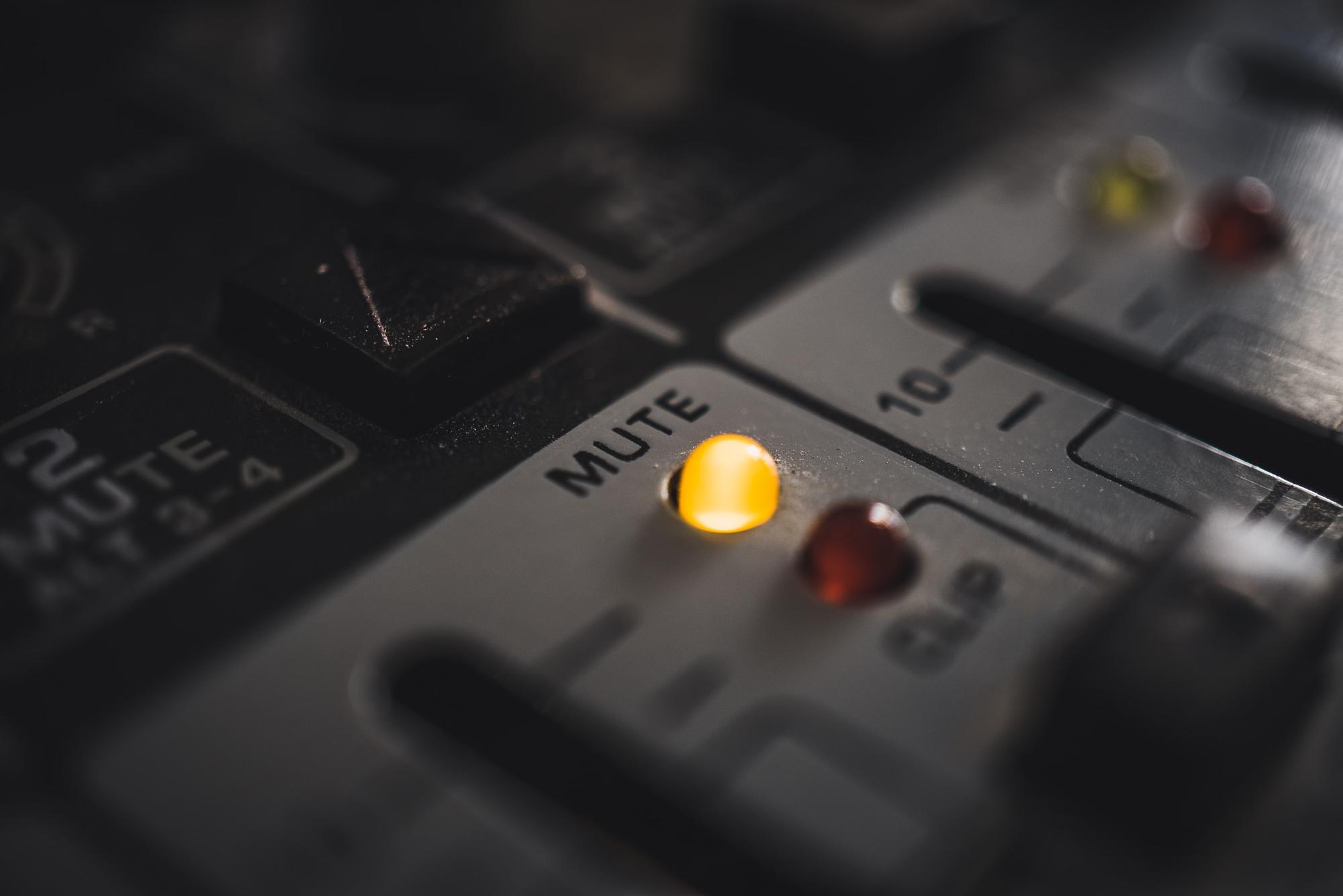 A mute LED on a modern, digital audio mixer.  by Mika Baumeister